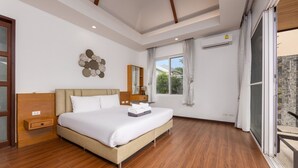 A hotel room with a large bed, a wooden floor, a window with curtains, and a balcony with a shower. - Villa Hemi 2BR Modern Thai Style (Choeng Thale)
