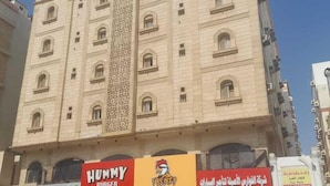 A multi-story building with a central decorative column. - Assistanceforfurnishedresidential units (Jeddah)