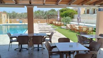 Seasonal outdoor pool, open 9:00 AM to 9:00 PM, pool loungers