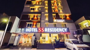 A multi-story hotel with a prominent sign reading "HOTEL SS RESIDENCY Stay Luxury." - Treebo SS Residency Gandhi Nagar (Vijayawada)