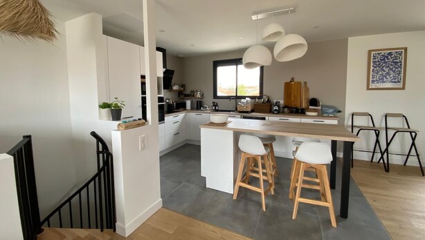 A modern kitchen with white cabinets, a wooden island, and bar stools. - HOUSE LE CLOS JOLY NEAR TRAIN STATION 3 BEDROOMS (Les Sables-d'Olonne)