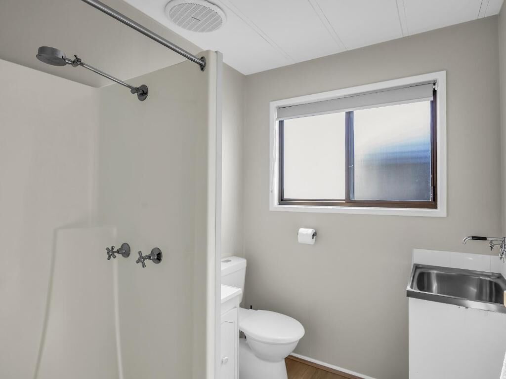 Un bagno con WC, lavandino e doccia.