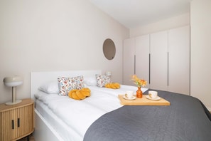 Cozy bedroom with a large double bed, neutral tones, and soft bedding. - Stylish Apartment | 800 m from Spodek and Balcony (Katowice)