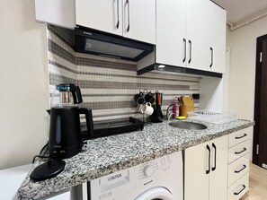 Fridge, stovetop, electric kettle, cookware/dishes/utensils