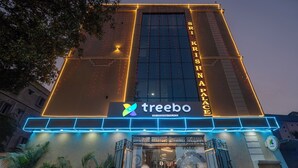 The exterior of Sri Krishna Palace hotel with a prominent entrance and illuminated signage. - Treebo Sri Krishna Palace (Bhubaneshwar)