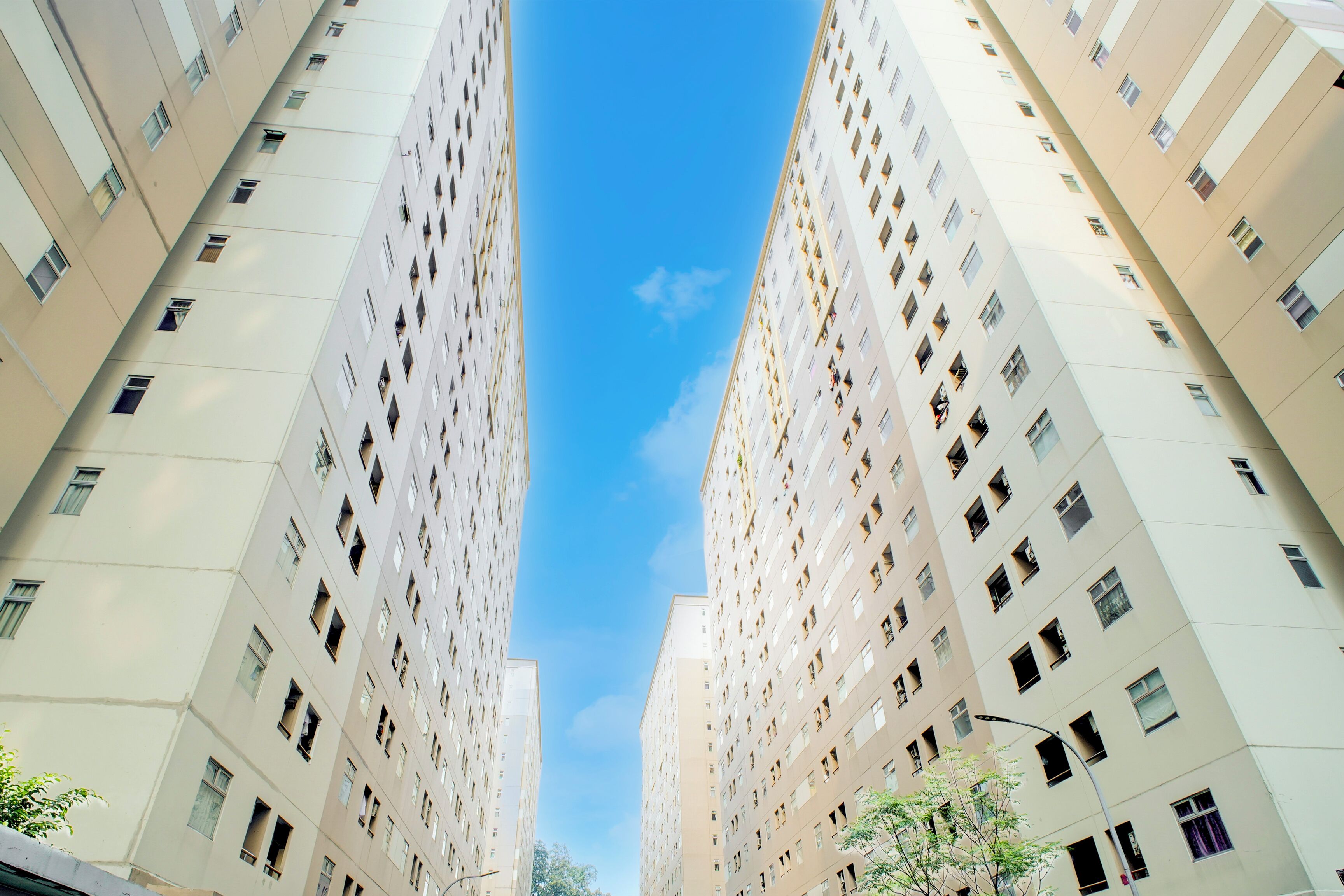 A high-rise residential building with multiple floors, featuring a uniform architectural style and numerous windows.