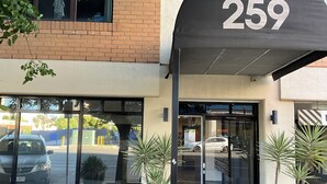 A building entrance with a number sign '259', large windows, and potted plants. - LOVELY ADELAIDE CITY ESCAPE (Adelaide)