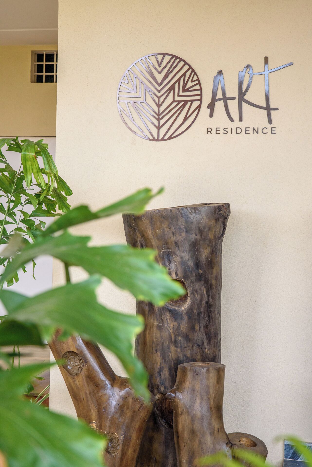 A wall-mounted logo with a circular design and the text "ART RESIDENCE".
