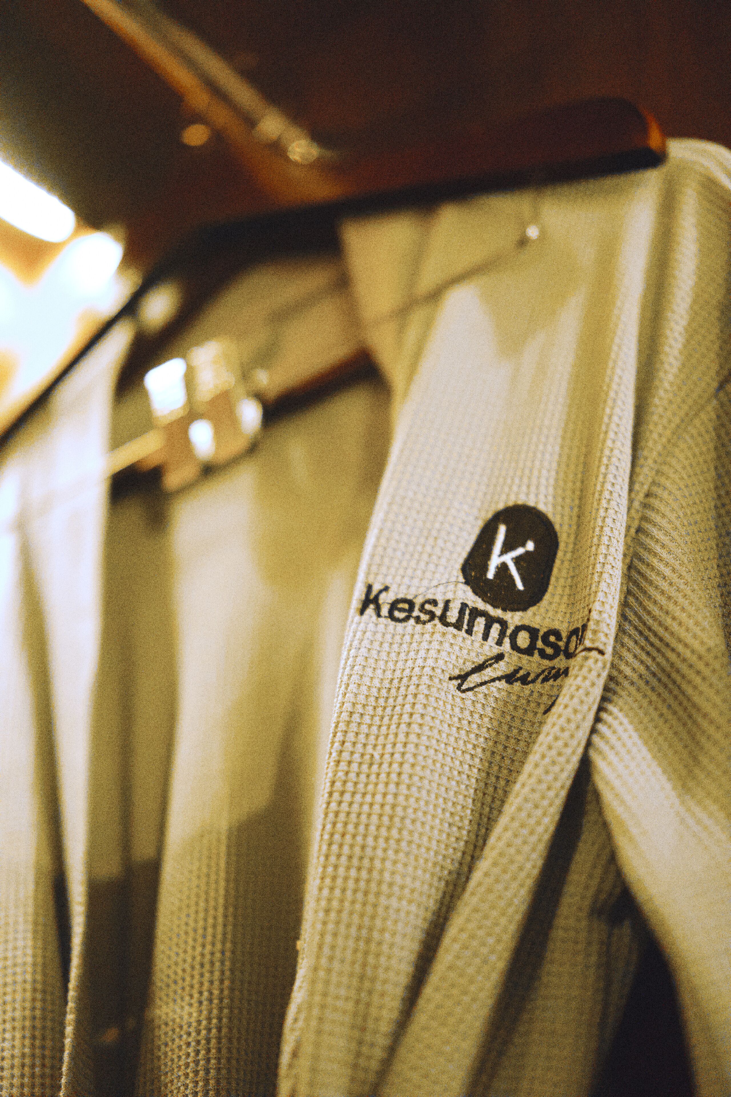 A close-up of a fabric with a visible logo and text, indicating a branded item.