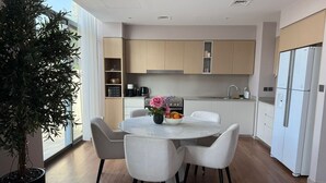 A modern kitchen with white cabinets, a built-in oven, and a stainless steel refrigerator. - Resort-Style - 4BR Villa, Arabian Ranches 3 (Dubai)