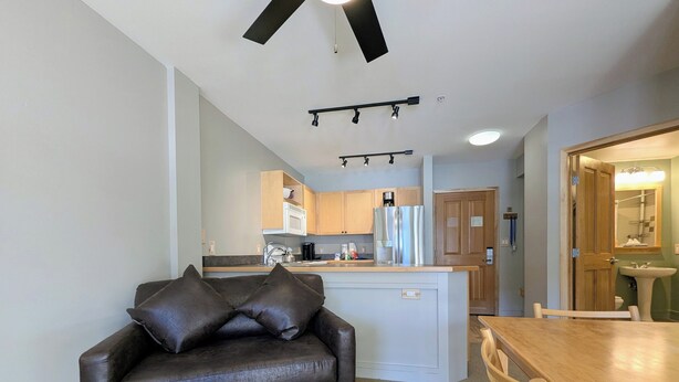 A compact living space with a sofa, a dining table, a kitchenette, and a bathroom. - New Listing! Top Floor w/Slope Views (Keystone)