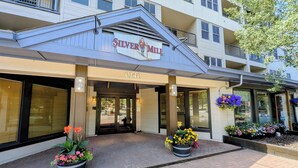 A hotel entrance with a sign reading 'Silver Mill' and the address '0140'. There are flower planters in front of the entrance. - New Listing! Top Floor w/Slope Views (Keystone)
