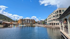 Ein Hotel direkt am Wasser mit mehreren Gebäuden, einem Anleger und Booten sowie blauem Himmel.
