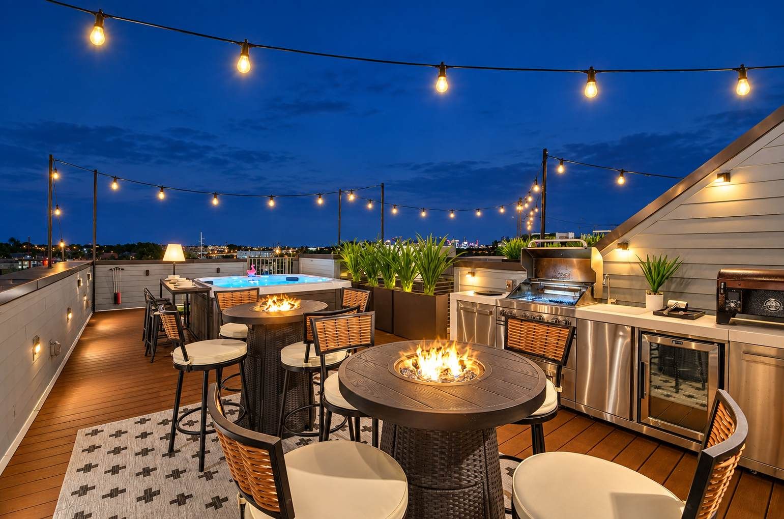 A rooftop patio with outdoor seating, a fire pit, and a grill area.