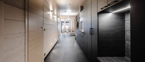 A modern kitchen with wooden cabinets and a dark countertop.