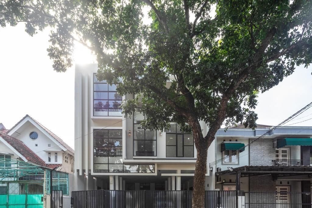 A modern two-story building with large windows and a balcony.