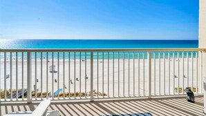 A balcony with a view of a beach and ocean. - BeachFront-5 Pools,Starbucks, Theater@Majestic 612 (Panama City Beach)