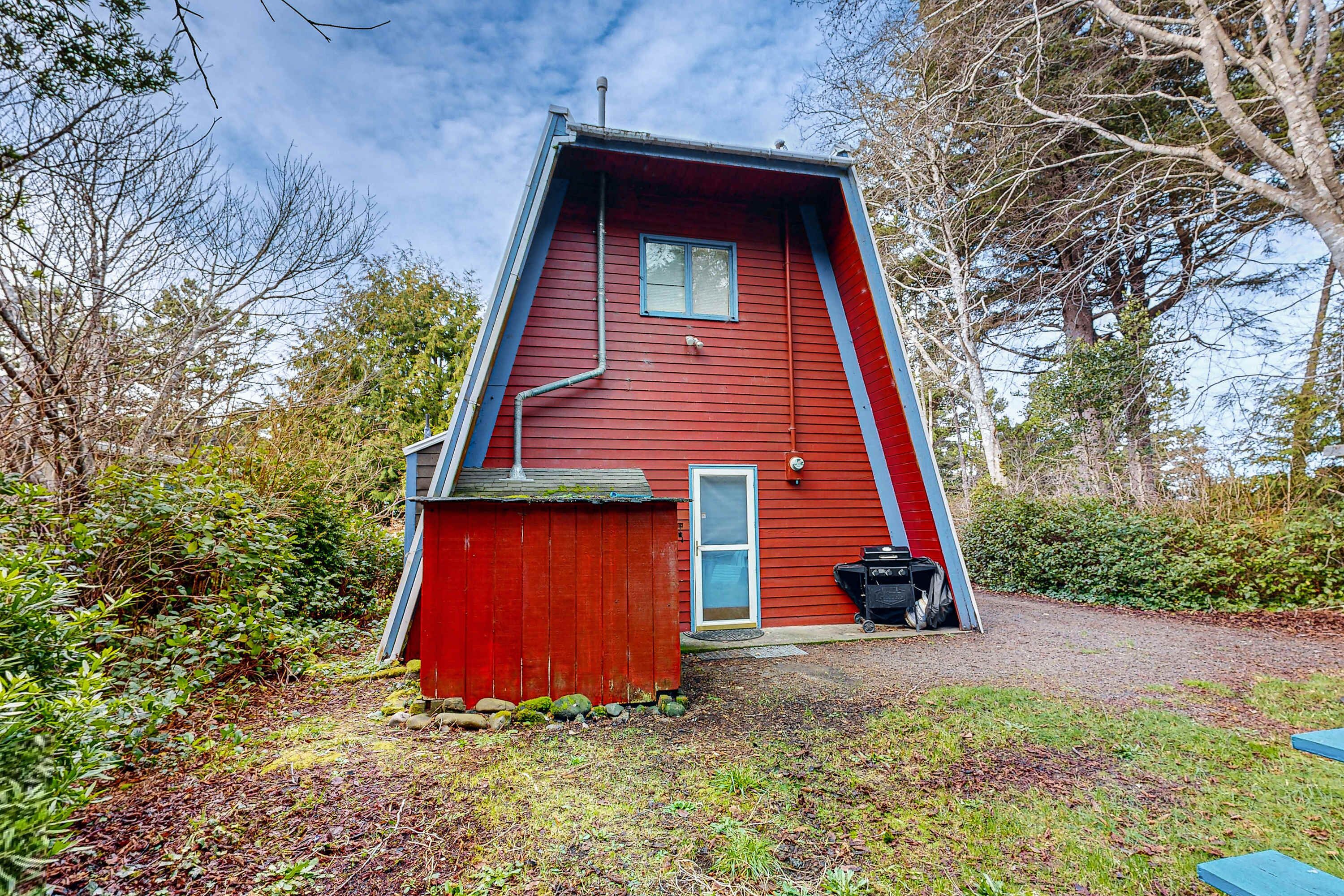 A red house with a sloped roof, a small window, and a door.
