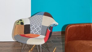 A room with a teal door, a rocking chair with a patchwork cushion, and a brown sofa. - San Giovanni prestige flat by RHR (Roma)