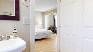 A hotel bathroom with a sink, mirror, and hand soap dispenser. - Lovely Studio with Great View and Nearby Beach Access Dogs Welcome (Lincoln City)