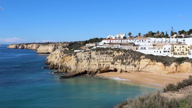 A coastal town with white buildings, a beach, and cliffs. - Dom Sancho Carvoeiro Beach Apartment Luxury (Carvoeiro)