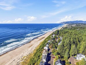 A coastal residential area with a beach, houses, and dense greenery. - Ocean Views, Hot Tub & Coastal Comfort (Lincoln City)