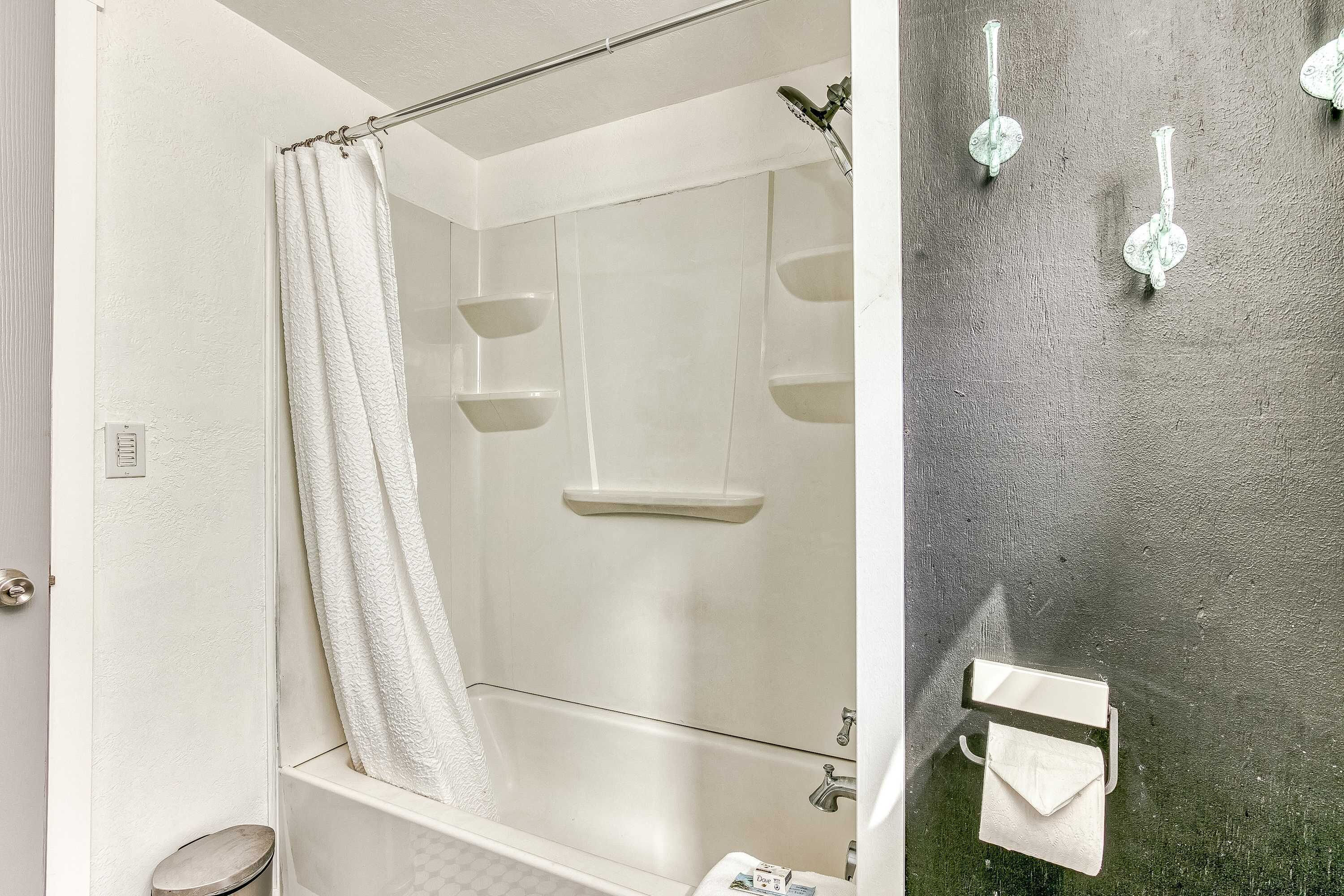 A bathroom with a shower, a bathtub, and a toilet.