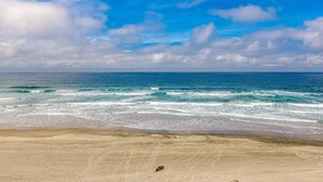 A beach with waves and a clear sky. - Ocean view home 1 block from the beach with hot tub deck and fireplace (Lincoln City)
