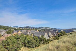A residential area with houses on a hillside, surrounded by trees and a clear sky. - Modern two story dog friendly home located close to beaches and trails (Pacific City)