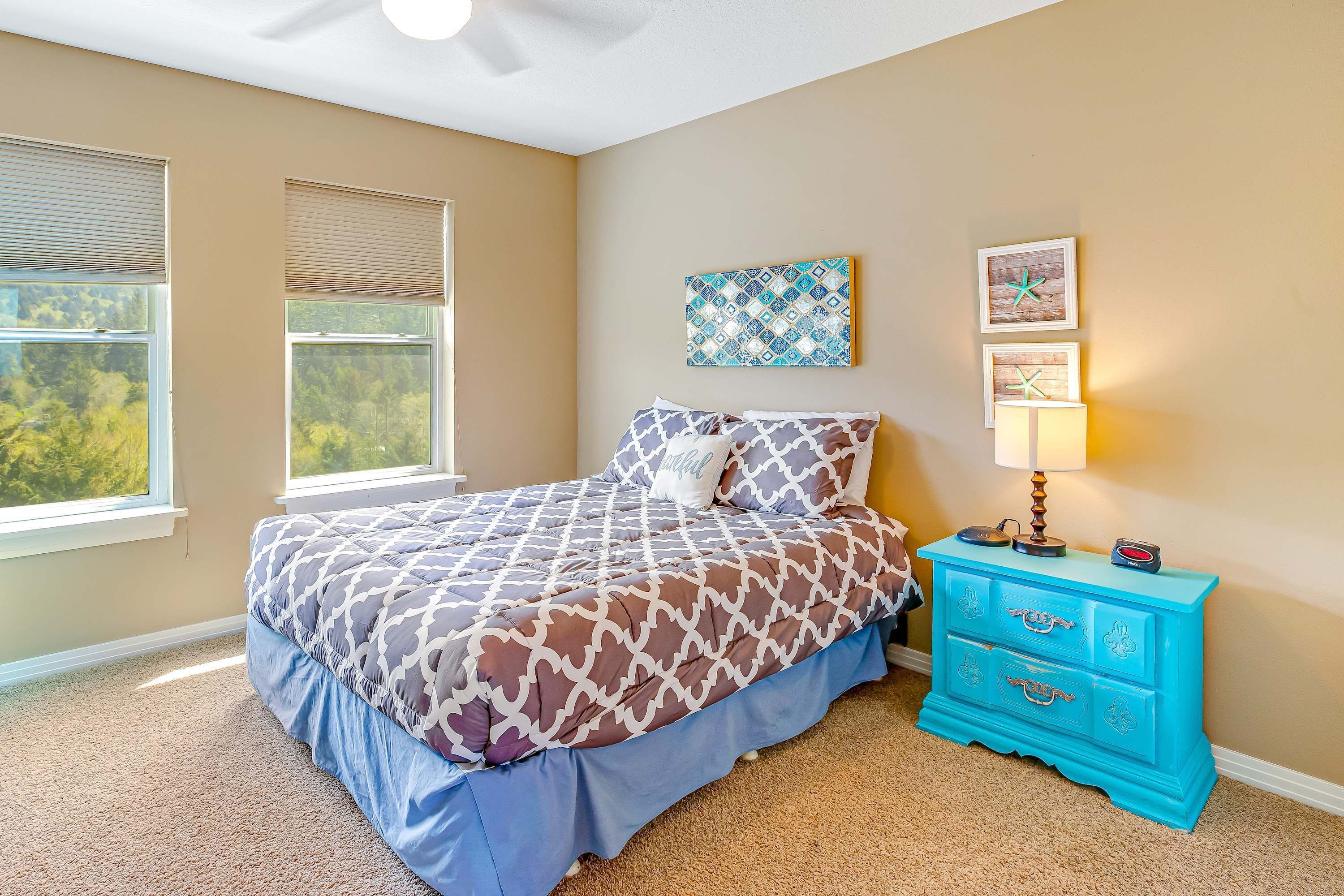 A bedroom with a bed, a dresser, and a window.