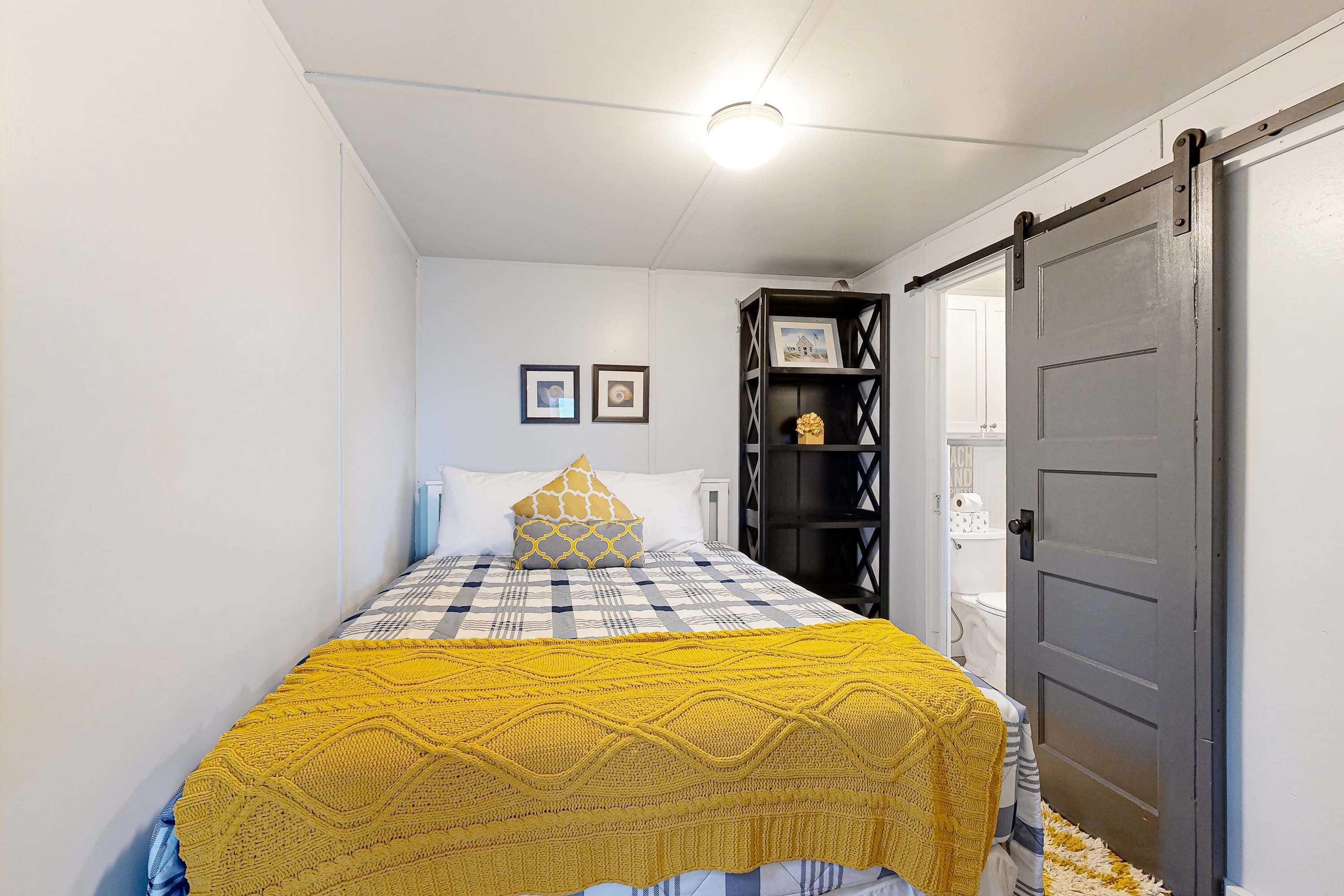 A bedroom with a bed, a wardrobe, and a door.