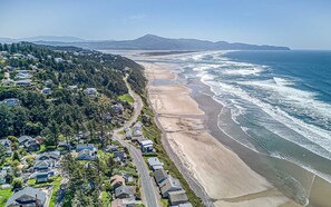 An aerial view of a coastal residential area with houses, a beach, and a road. - Downstairs Oceanview Hideout with Sweeping Views and Easy Beach Access (Oceanside)