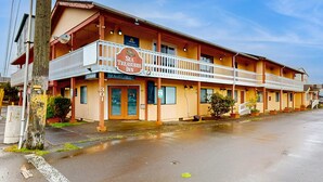 A two-story motel with a balcony on the second floor, a sign reading "Sea Treasures Inn," and a number "301" on the door. - Classy Dog Friendly Studio with Free WiFi and Cable Walk to the Beach (Rockaway Beach)