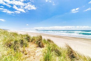 A beach with sand dunes and the ocean. - Inviting Room Blocks From the Beach and Downtown Dogs Welcome (Rockaway Beach)