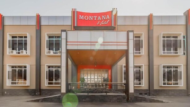 A hotel entrance with a red sign reading "MONTANA Hotel". - Sangkan Hurip Kuningan Hiyel (Cilimus)