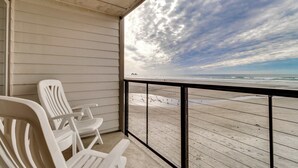 A balcony with a view of the beach. - Oceanfront condo with a full kitchen balcony and sweeping sea views (Rockaway Beach)