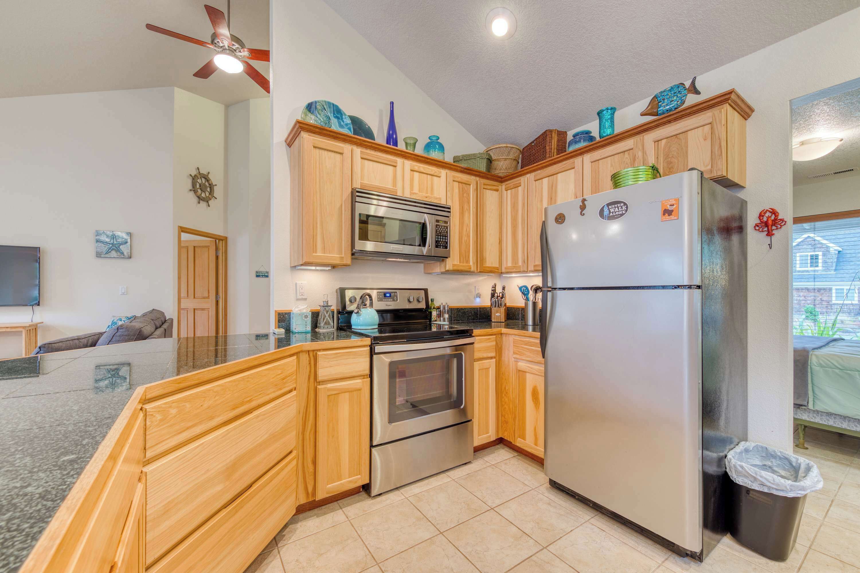 A modern kitchen with wooden cabinets, stainless steel appliances, and decorative items on the countertop.