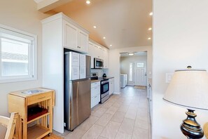 Coffee/tea maker, fridge, microwave, oven - Beachfront home with ocean facing deck and ocean views throughout modern kitchen (Rockaway Beach)