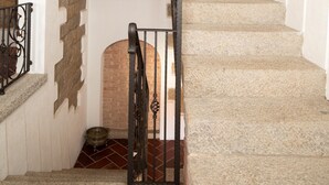 A staircase with stone steps and a wooden handrail, leading to a higher floor. - Casa al Duomo by Wonderful Italy (Telti)