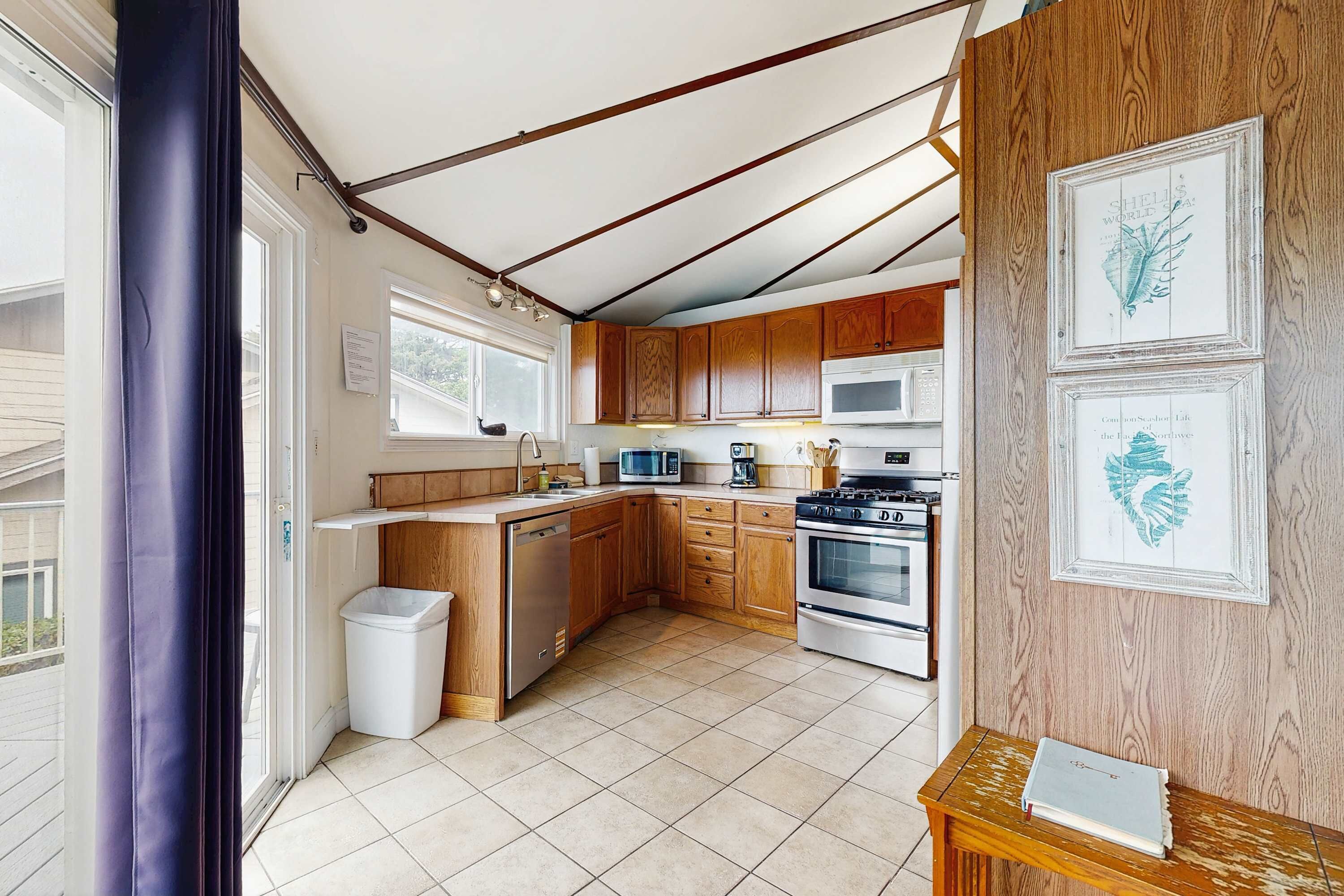 A kitchen with wooden cabinets, a microwave, a stove, and a dishwasher.