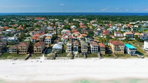 An aerial view of a coastal residential area with houses, a beach, and a clear view of the ocean. - Games, Elevator, Ensuites, Pool, Bikes, Elevator (Destin)
