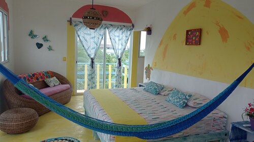 Colorful room very close to the beach. Only one lot behind the best beach.