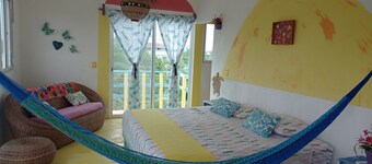 Colorful room very close to the beach. Only one lot behind the best beach.