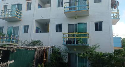 Colorful room very close to the beach. Only one lot behind the best beach.