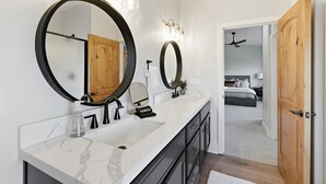 A modern bathroom with a large mirror, two sinks, and a vanity with a makeup station. - HotTub+Sauna+Garage+DeerValleyEast+Jordanelle (Heber City)