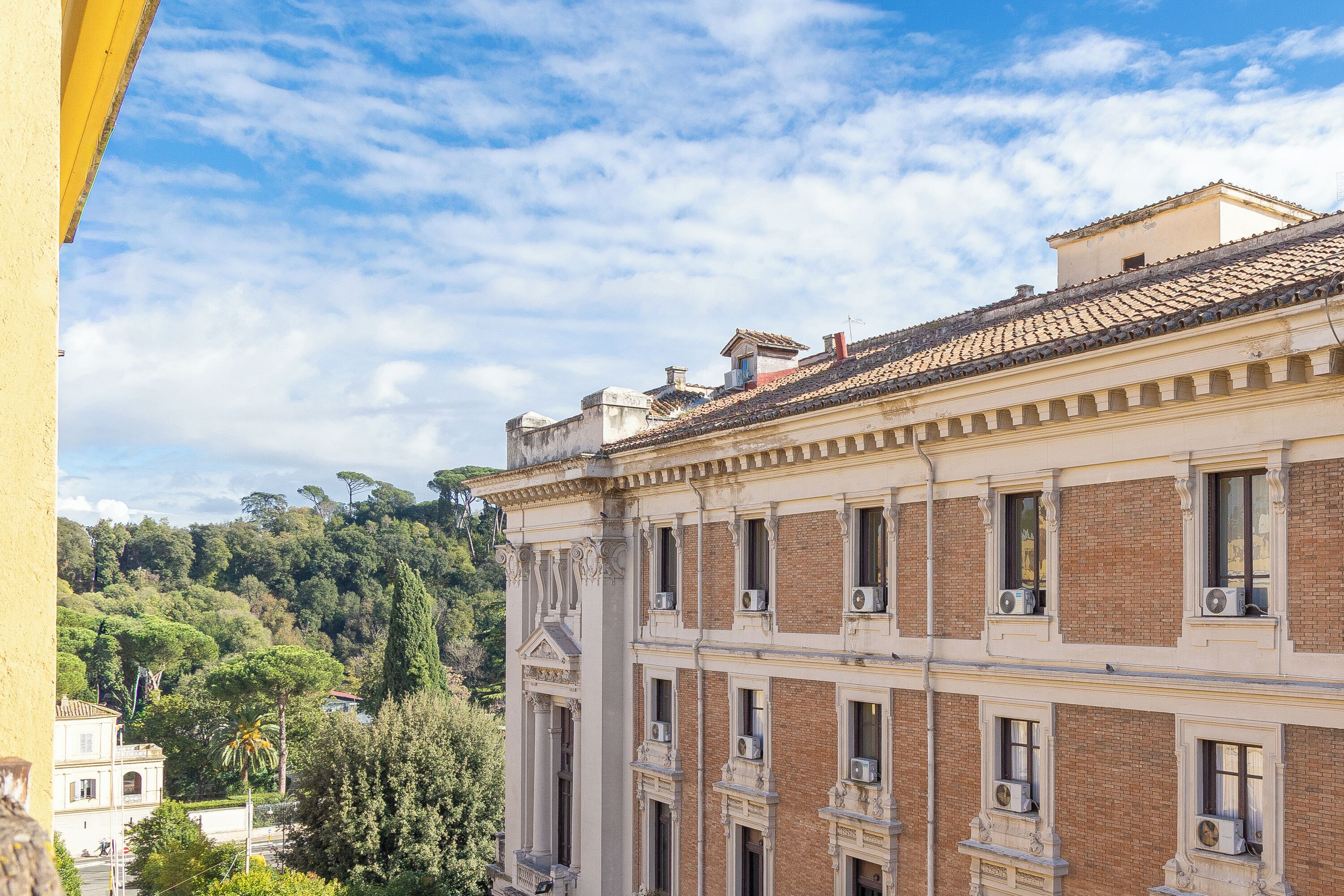 A multi-story building with classical architecture, featuring columns and decorative moldings.