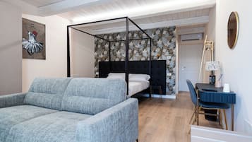 Deluxe Quadruple Room | In-room safe, desk, laptop workspace, blackout drapes