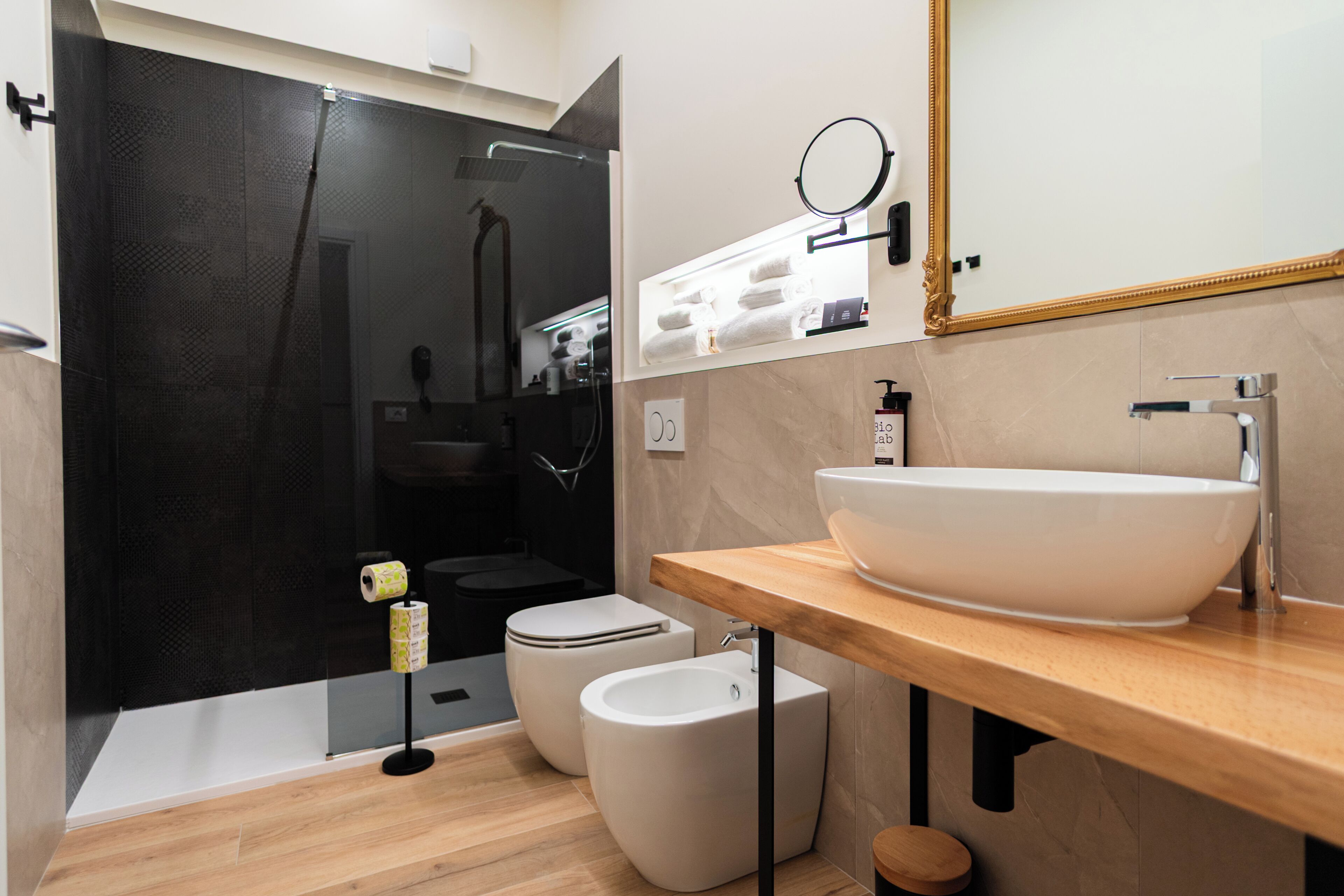 Une salle de bain moderne avec un grand lavabo blanc, un miroir et un espace douche.