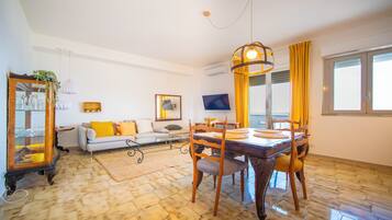 Apartment, Sea View | Living area | 32-inch flat-screen TV with cable channels