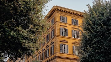 En bygning i flere etager med klassisk arkitektur, kendetegnet ved symmetriske vinduer og en central indgang.